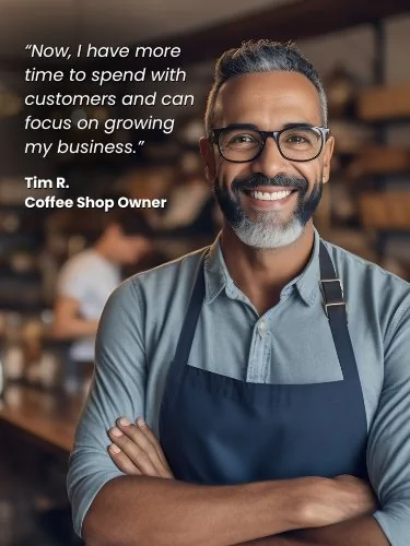middle aged male coffee shop owner standing in front of coffee bar